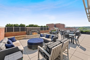 Rooftop terrace fireplace and chairs at Bradley Braddock Road Station Apartments in Alexandria VA